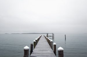 A dock with snow on the end of it