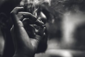 A person holding a cigarette in their hand.