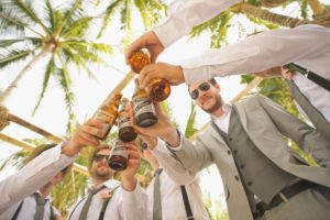 A group of men holding beers in their hands.