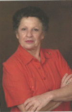 A woman in red shirt with arms crossed.