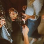 A group of people holding wine glasses in their hands.