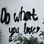A wall with graffiti that reads " do what you love ".