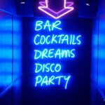 A neon sign that says bar cocktails dreams disco party.