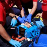 A group of people in red shirts and blue gloves.