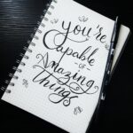 A notebook with the words " you 're capable of amazing things ".