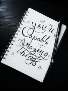 A notebook with the words " you 're capable of amazing things ".